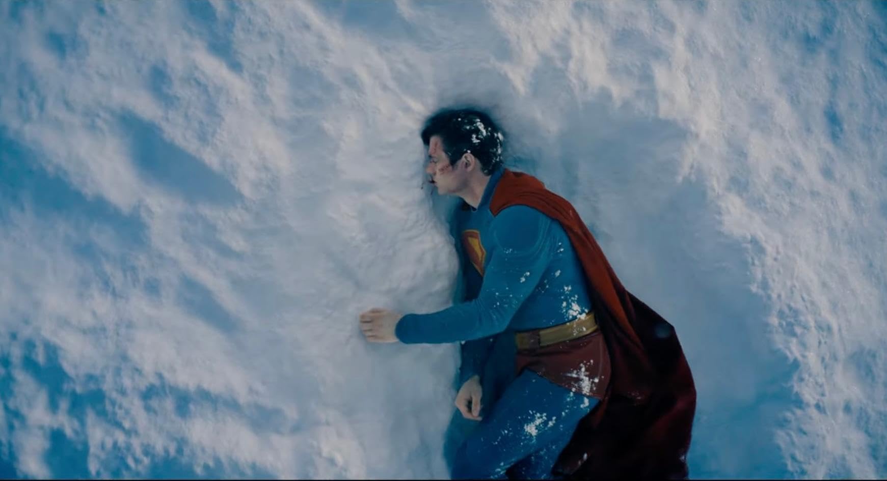 A battered superman lying in the snow